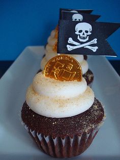 a cupcake with a pirate flag on top and a bitcoin in the middle