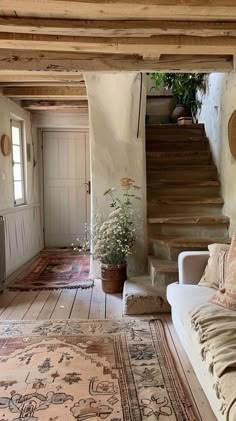 a living room filled with lots of furniture and rugs