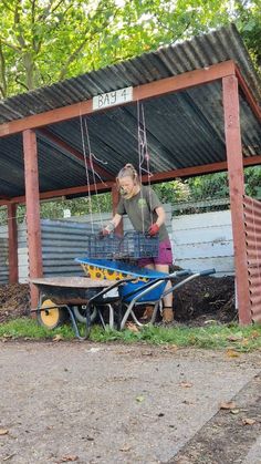 a woman standing next to a blue wagon