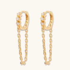 Bring edge and style to any look with these Sienna Huggie Hoops! These ultra-chic earrings feature an edgy yet stylish hoop design that's perfect for any occasion. flaunt your unique style with these fabulous must-haves! We cannot stop wearing these on repeat here at L&T headquarters! Features: 18k gold plated Sterling Silver 12mm in diameter 1 inch drop Cubic Zirconia Hinge post closure Trendy Gold Plated Dangle Hoop Earrings, Party Dangle Huggie Earrings, Trendy Huggie Earrings For Party, Party Huggie Dangle Earrings, Party Huggie Hoop Earrings, Tarnish Resistant Small Hoop Earrings For Party, Hoop Design, Chic Earrings, On Repeat