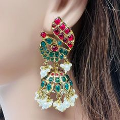 High quality peacock design indian jhumka earrings detailed with green,ruby color stone and pearls it looks more classy. Lightweight and elegant. Earrings length: 3 inches  Earrings width: 1.4 inches  You can also prafer it as a gift for someone special on their birthday,anniversary or any special occasion to make their day and let them remember you whenever they wear it. Occasion to wear: Party, wedding, marriage, kitty parties and any special occasion. Care instructions: Avoid Heat and Chemica Indian Jhumka, Ruby Color, Kitty Party, Peacock Design, Jhumka Earrings, Cat Party, Ruby Stone, Earrings Green, Design Earrings