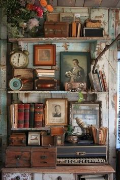 an old desk with many books and pictures on it