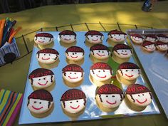 cupcakes with faces on them sitting on a table