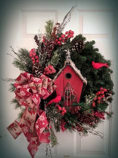 a wreath with a birdhouse on it