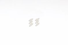 The Miri are stud earrings with 3 baguette cut cubic zirconias. These tiny, dainty, modern, minimalist-style earrings can be worn on the first and second hole as well as on the cartilage piercing. Perfect for a gift! Features: * Size: 7.5 x 3.5 mm * They are sold in singles and in pairs. Both options are available on the dropdown menu. * All of our jewelry is made of sterling silver (925 mm), and our gold jewelry is gold plated in 18K gold. Nickel free. Packaging: Our jewelry is packaged in a re Modern White Baguette Cut Earrings, Minimalist Baguette Diamond Earrings For Anniversary, Minimalist Baguette Cut Earrings For Anniversary, Minimalist Earrings With Baguette Diamonds, Cz Stud Earrings, Cartilage Piercing, Baguette Cut, Single Earring, Style Earrings