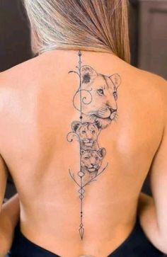 the back of a woman's neck with an arrow and lions on it