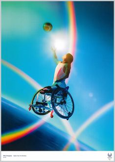 a man in a wheel chair is flying through the air with a rainbow behind him