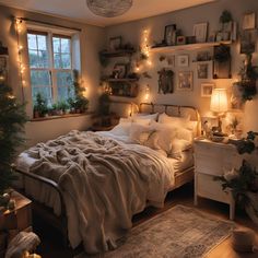 a bedroom with lights on the wall and a bed covered in blankets next to a window