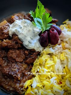 a close up of a plate of food with rice and meat