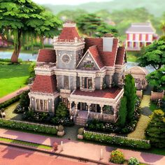 a very big pretty house in the middle of some trees and bushes with a clock on it's tower