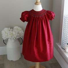 This Strasburg Dress In Size 24 Months Is Adorable. Made Of 100% Silk In A Gorgeous Scarlett Red. The Bishop Style Is Timeless And Classy. The Hand Smocked Collar Has Lovely Red Satin Ribbon Braided In The Center Of The Smocking.Each Row Of Smocking Is Trimmed In A Silver Metallic Embroidery Threading. So Simple, Yet Elegant!! The Puff Sleeves Are Smocked As Well And Have The Same Smocking With Silver Metallic Embroidery. The Red On Red Is Just Lovely! The Upper Back Has A Four Button Closure (Fabric Covered Buttons -A High End Feature) Worn Once And Professionally Laundered. No Flaws Or Defects- Excellent, Beautiful Condition! Great For Little Flower Girls, Church, Seasonal Portraits Or Pa Scarlett Red, Smocked Bishop Dress, Ribbon Braids, Smocked Clothes, Silk Vest, Metallic Embroidery, Hand Smock, Fabric Covered Button, Red Satin