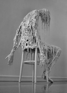 a chair that is covered in some kind of cloth on it's back legs