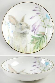 a white bowl with an image of a rabbit in the center and purple flowers on it