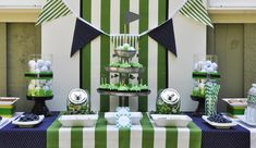 a green and white dessert table with cupcakes