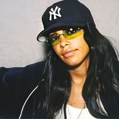 a woman wearing a new york yankees hat and sunglasses