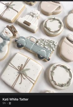 cookies decorated with white and blue icing are arranged in the shape of an old car