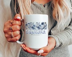 a woman holding a coffee mug with the word charmia printed on it