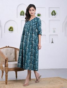 This printed ethnic wear dress is presented to you, A well-known brand in hand block prints from over 9 decades. This exclusively hand stitched dress is made of 100% pure cotton fabric with having printed prints over it. The dress is best suitable for you to showcase your women hood. Wear this at your ease and the fabric is so smooth to skin that you will love it and the attractive prints adds more charm to the same. Material : 100% Cotton dress Length : 54 Inches Disclaimer : As the fabric is block printed , It may have slight irregularities in colors and prints. These irregularities are the stamp of authenticity of all hand block printed products. Actual product may vary due to lighting conditions. Wash Care & Instructions : Gentle Hand Wash Separately In Cold Water With Mild Liquid Dete Festive Cotton Ikat Print Dress, Traditional Cotton Dress With Kalamkari Print, Festive Cotton Block Print Dress, Cotton Anarkali Dress With Block Print, Summer Mulmul Dresses With Printed Motifs, Summer Dresses With Printed Motifs In Mulmul, Festive Cotton Floral Print Dress, Indigo Cotton Kurta With Block Print, Blue Printed Anarkali Kurta