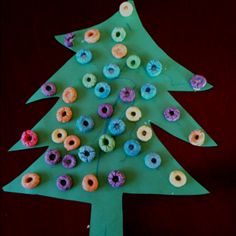 a paper plate christmas tree made with doughnuts