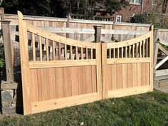 a wooden gate in front of a house