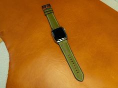 Apple Watch Strap with Rubber Backing Leather watch bands are always in style, their appearance is timeless and considered to be a classic. This apple watch strap, crafted from Italian leather, boasts a remarkable feature: a rubber backing that renders it suitable for use during sports activities. It's very comfortable to wear and easily shapes to your wrist after a short time of regular wear. To add a touch of visual appeal, the watch strap has contrasting white stitching. It's available for al Green Leather Watch Accessories For Business, Green Leather Business Watch Accessories, Business Green Leather Watch Accessories, Green Leather Watch Bands For Everyday Use, Classic Green Leather Watch Band, Classic Green Watch Accessories For Everyday Use, Modern Green Watch Accessories For Everyday Use, Green Leather Modern Watch Accessories, Modern Green Leather Watch Accessories