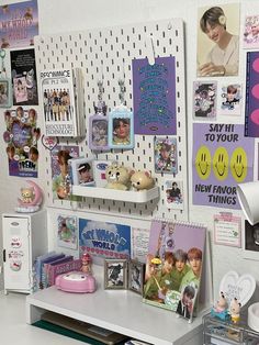 a white desk topped with lots of pictures and magnets