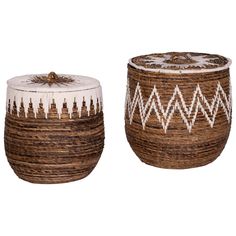 two woven baskets sitting next to each other on top of a white surface with a brown lid