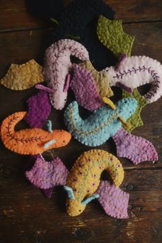 several crocheted animals are arranged on a wooden surface