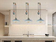 a kitchen with four lights hanging from the ceiling