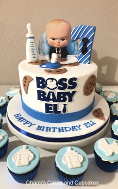 a baby shower cake with cupcakes around it and an image of a baby on top