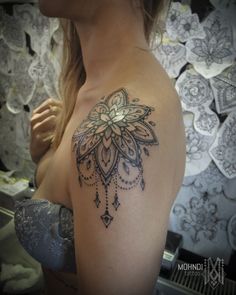 a woman with a tattoo on her shoulder