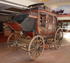 an old fashioned horse drawn carriage in a museum