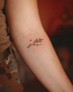 a person with a small tattoo on their arm