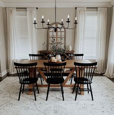 a dining room table with chairs and a chandelier