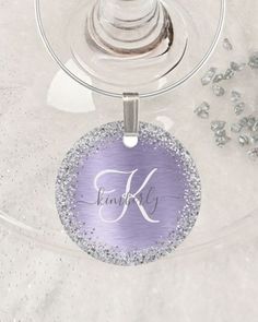 a wine glass with a name on it and some silver beads around the rims