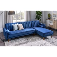 a living room with a blue couch and ottoman