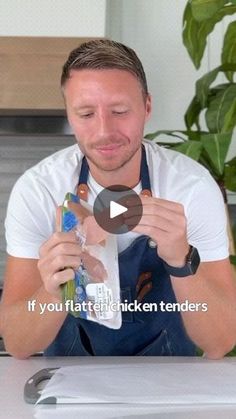 a man in an apron is holding some food