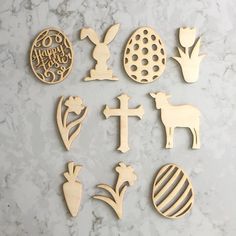 wooden cutouts with easter symbols on a marble surface