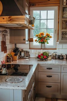 a kitchen filled with lots of counter top space next to a stove top oven and sink