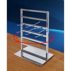 a metal rack with several pairs of glasses on it and an arrow pointing to the bottom