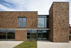 a large brick building with lots of windows and doors on the side of it's sides