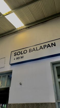 the sign on the wall says soloo balapan and is hanging from the ceiling