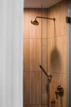 a shower with wooden walls in a bathroom