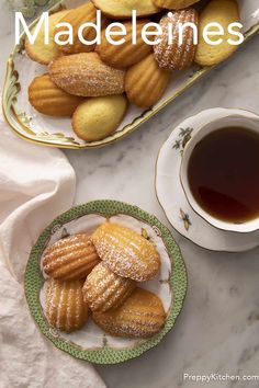 cookies and tea on a marble table with the words madelines above it in white lettering