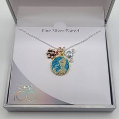 the disney princess necklace in its box is decorated with swarongs and charms