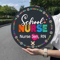 a person holding up a sign that says school nurse