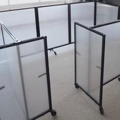 an office cubicle with four partitions on wheels