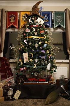 a decorated christmas tree in front of a window with harry's hat on top