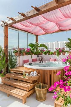 a hot tub sitting on top of a wooden deck next to flowers and potted plants