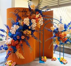 an orange and blue display with flowers on it